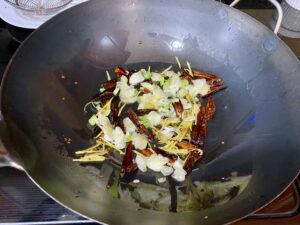 Scallions and Garlic go in for General Tso's Chicken