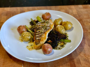 Crispy Skin Wild Black Bass with Beurre Blanc, Roasted Baby Potatoes, & Charred Broccolini